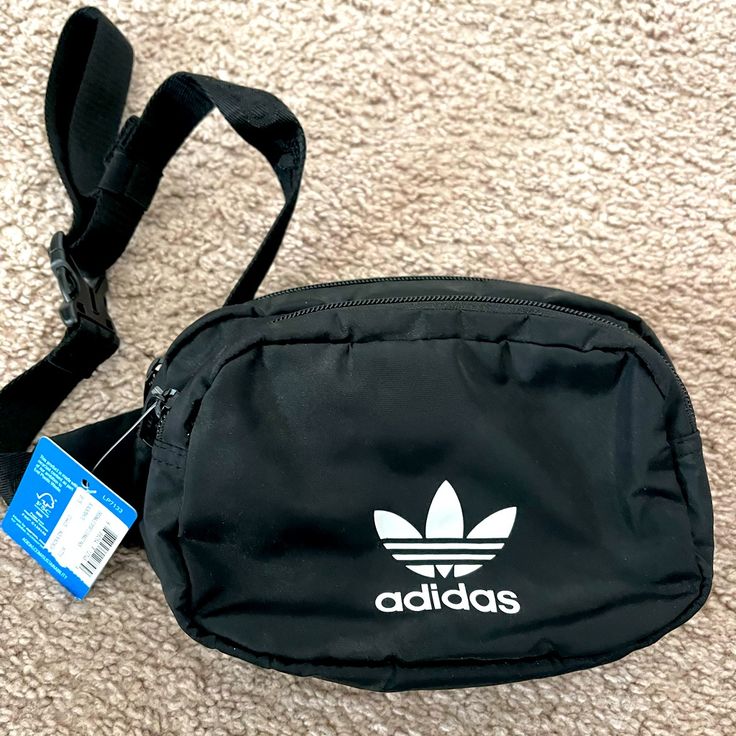 Adidas Fanny Pack New With Tags Across Your Body Or Around Your Waist, Any Way You Style It, This Adidas Waist Pack Is The Perfect Size. Zip Pockets Provide Easy Access To Your Essentials And Keep Your Small Stuff Organized Multiple Zip Pockets Adjustable Waist Strap Adjusts Up To 58 Inches Hidden Zip Pocket Interior Earbud And Charger Storage Color: Black Crossbody Fanny Pack Adidas, Casual Adidas Shoulder Bag For Travel, Adidas Casual Crossbody Shoulder Bag, Casual Adidas Crossbody Shoulder Bag, Adidas Casual Crossbody Bag, Casual Adidas Black Bag, Casual Adidas Shoulder Bag For School, Adidas Casual Bags For Outdoor Activities, Casual Adidas Bags For Outdoor Activities