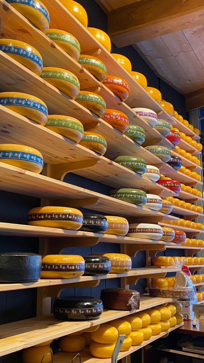 shelves filled with lots of different types of cheese