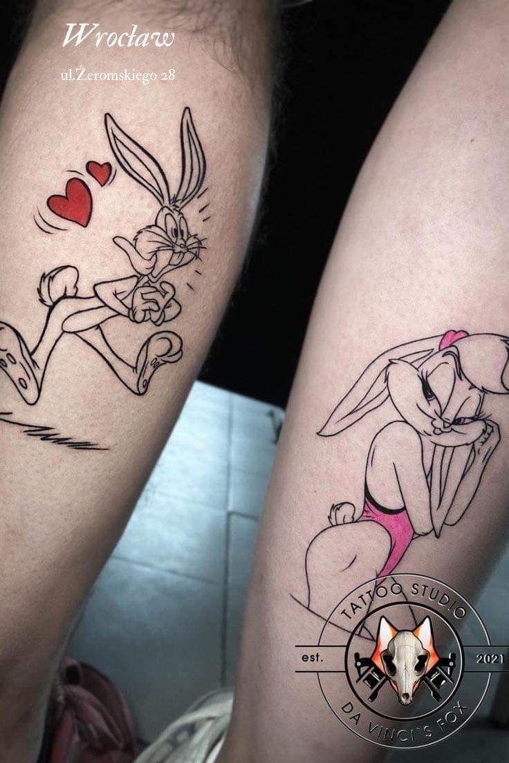 two people with tattoos on their legs, one has a rabbit and the other has a heart