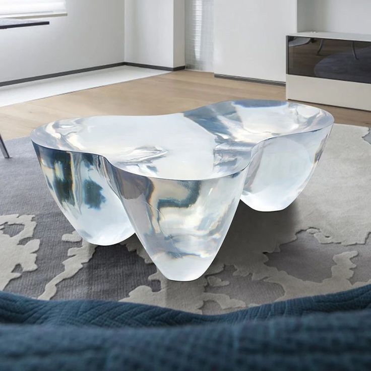 a glass coffee table sitting on top of a rug