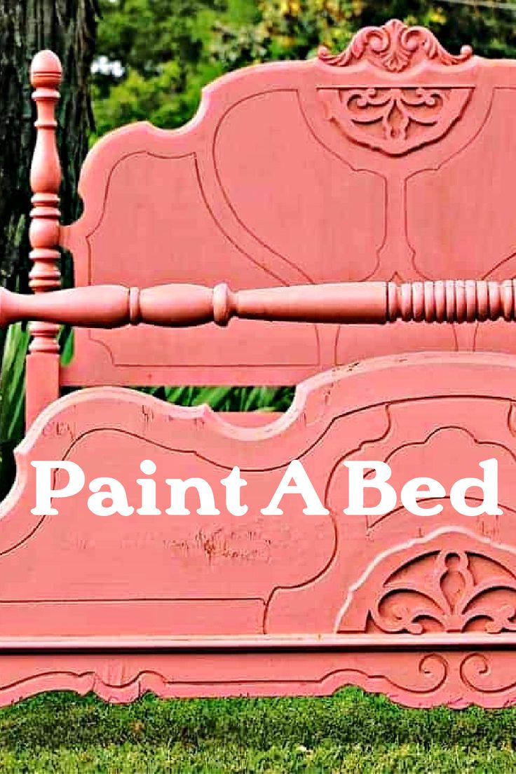 a pink painted bed sitting in the grass