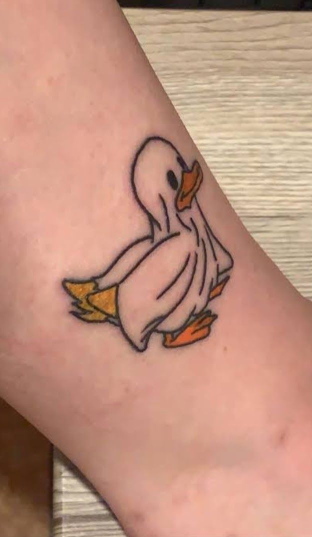 a small duck tattoo on the ankle