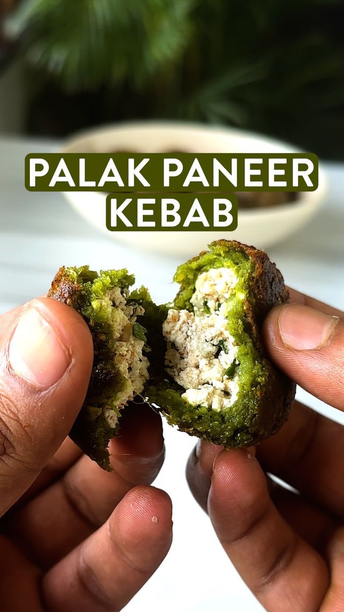 two hands holding up a half eaten food item with the words palak paneer kebab