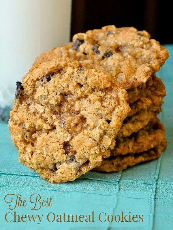 three cookies and a glass of milk on a blue tablecloth with a teal cloth