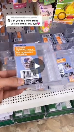 a person holding up a plastic container in a store