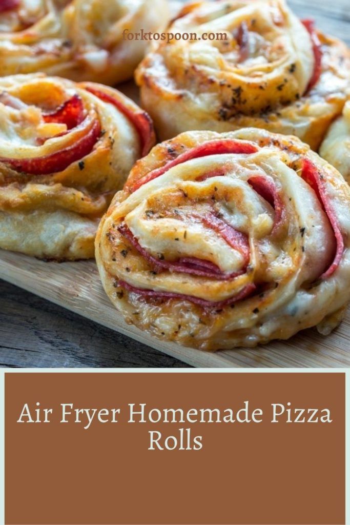 homemade pizza rolls on a cutting board with text overlay that reads air fryer homemade pizza rolls