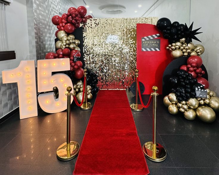 a red carpeted hallway with gold and black decorations on the wall, and a number fifteen sign