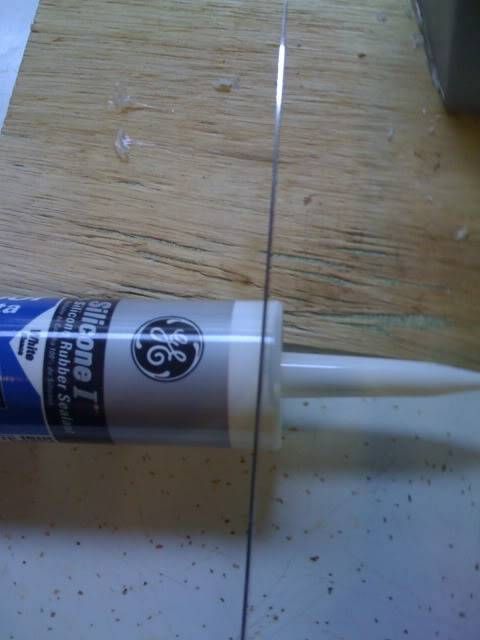 a tube of glue sitting on top of a wooden table