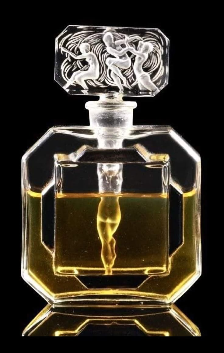 an empty glass bottle with a figure in the center on a black background, it appears to be filled with liquid