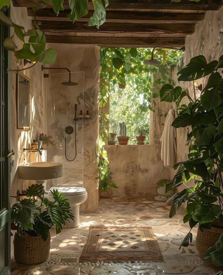 an open bathroom with plants in the corner and a toilet on the other side that is surrounded by greenery