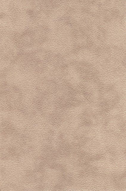 an image of a beige leather textured background that looks like it has been used as a wallpaper