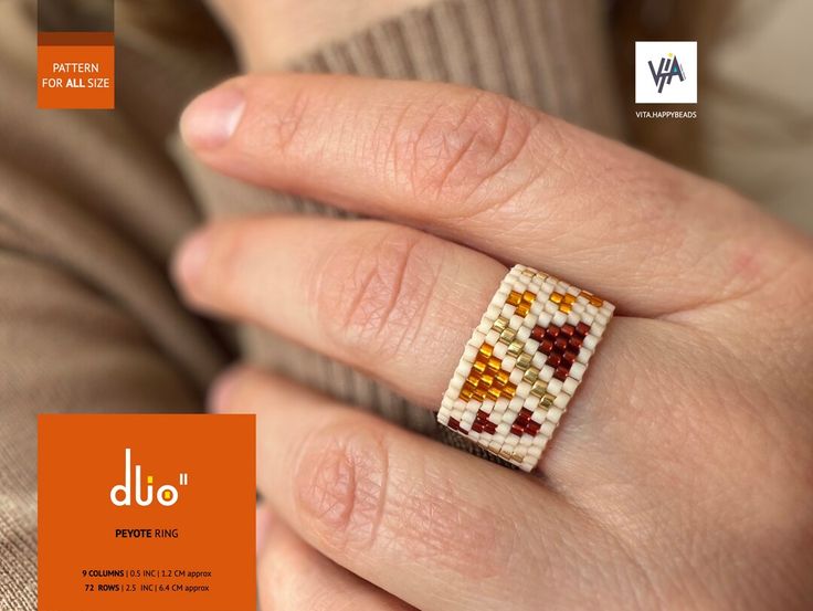 a woman's hand with a beaded ring on top of her finger and an orange background