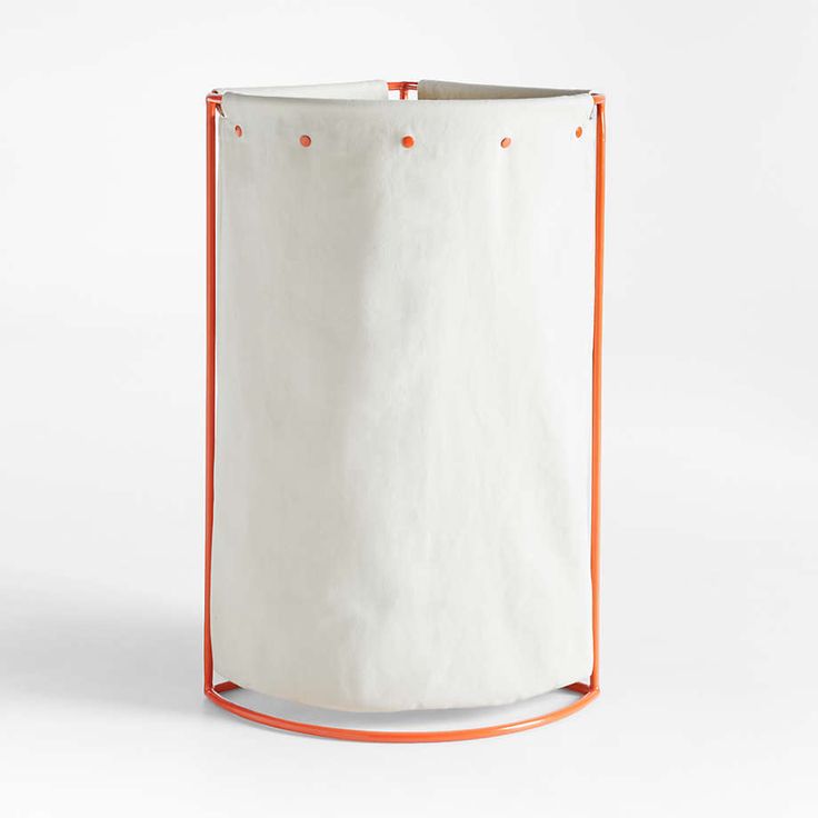 a white bag with an orange handle on the bottom and inside, sitting in front of a white background