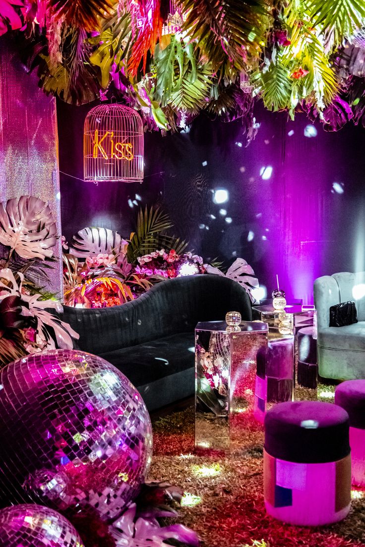 a living room filled with furniture and disco balls