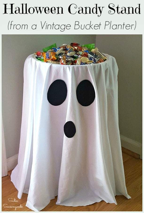 a white table with black polka dots on it and a ghost decoration in the middle