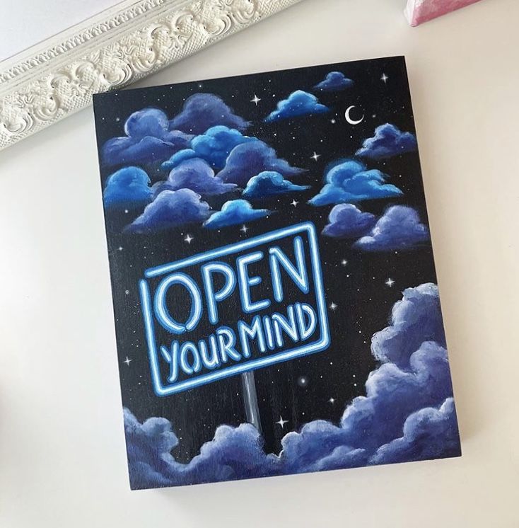 an open your mind poster hanging on the wall