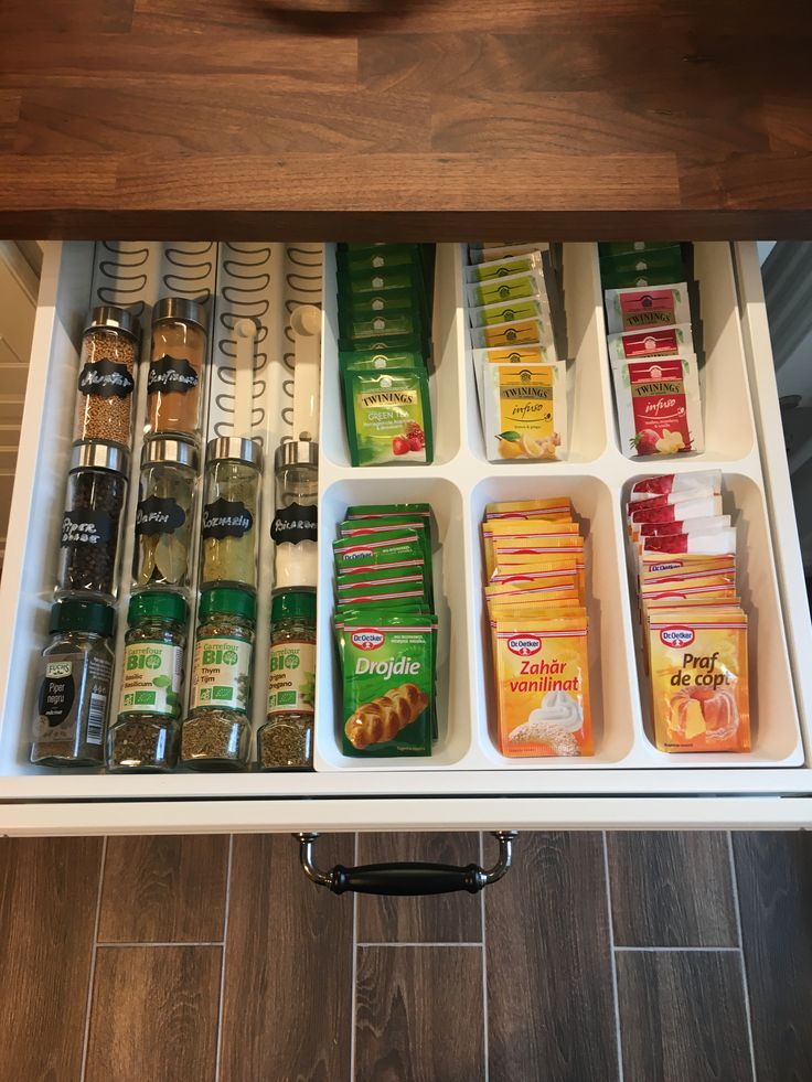 an open drawer with spices and condiments in it