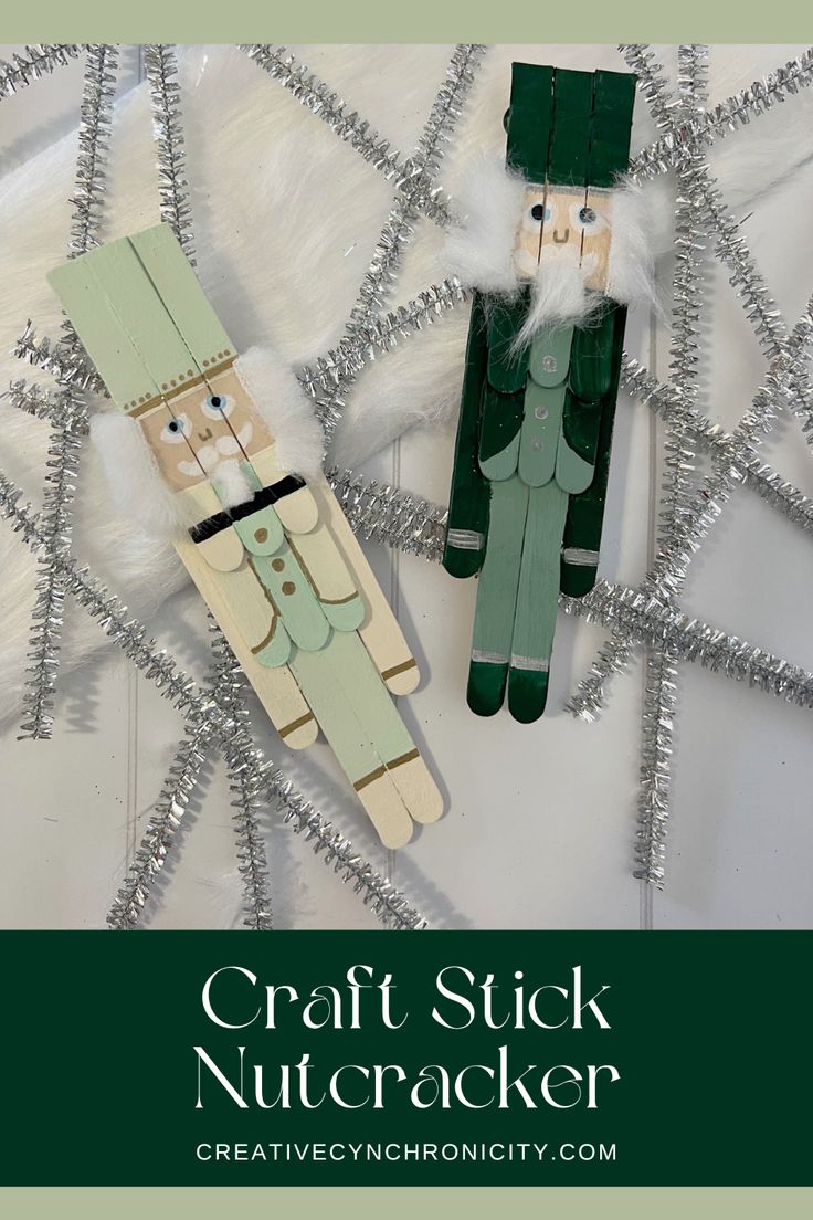 the craft stick nutcracker is made from wood and has two wooden figures on it