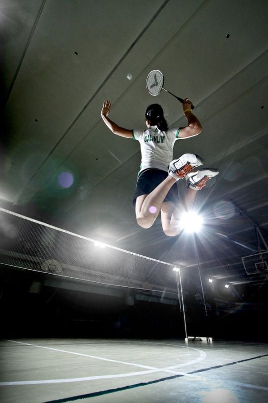 a person jumping in the air with a tennis racket