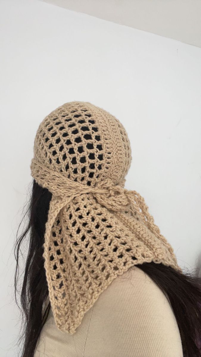 a woman's head wearing a knitted hat with a crochet pattern