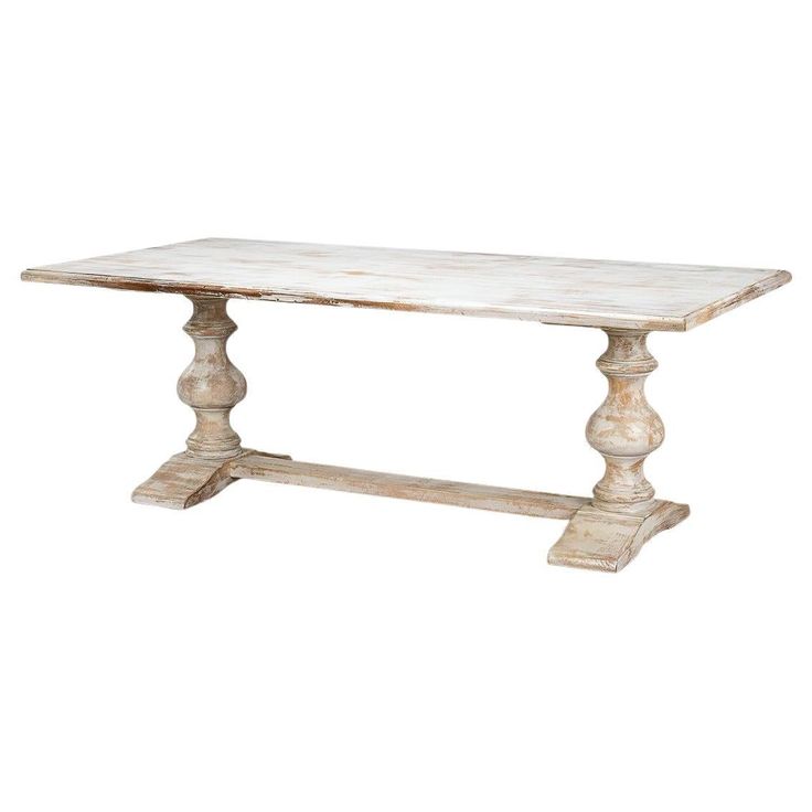 a white marble table with wooden legs and an old style design on the top, against a