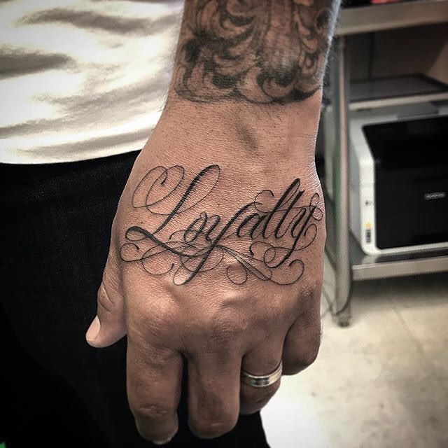 a man's hand with the word lofaday tattooed on it and his name in cursive font