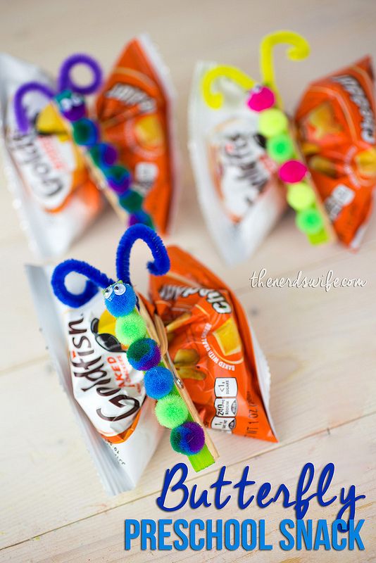 three candy bags with pom - poms on them and the words butterfly pre school snack