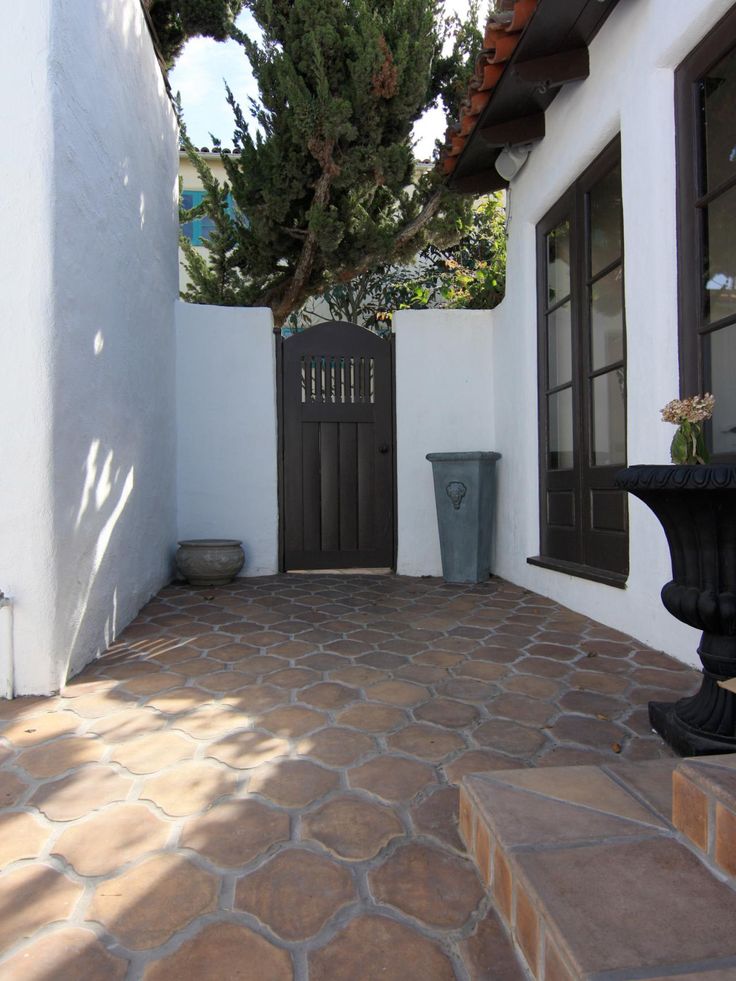 an outdoor patio area with stone steps and potted planter on the right side