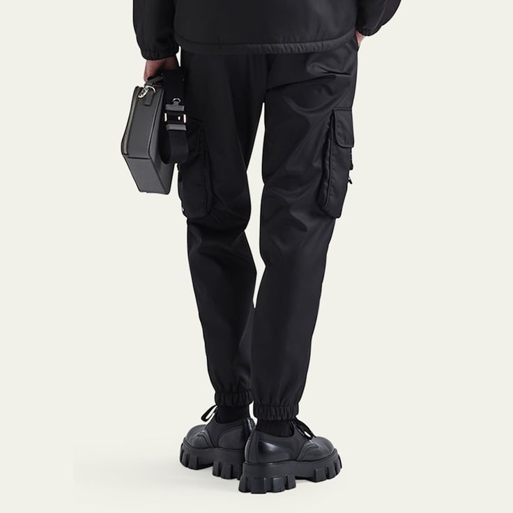 Prada pants in recycled-nylon  Regular rise Four-pocket style Leg pockets with buckles Skinny legs Full length Elastic hem  Nylon/polyamide Made in Italy Techwear Nylon Bottoms With Multiple Pockets, Functional Nylon Pants With Belt Loops, Nylon Cargo Pants With Multiple Pockets For Techwear, Utility Nylon Pants With Multiple Pockets, Nylon Pants With Belt Loops For Outdoor, Functional Nylon Bottoms With Belt Loops, Nylon Pants With Belt Loops For Outdoor Activities, Black Nylon Cargo Pants For Work, Utility Nylon Cargo Pants With Functional Pockets