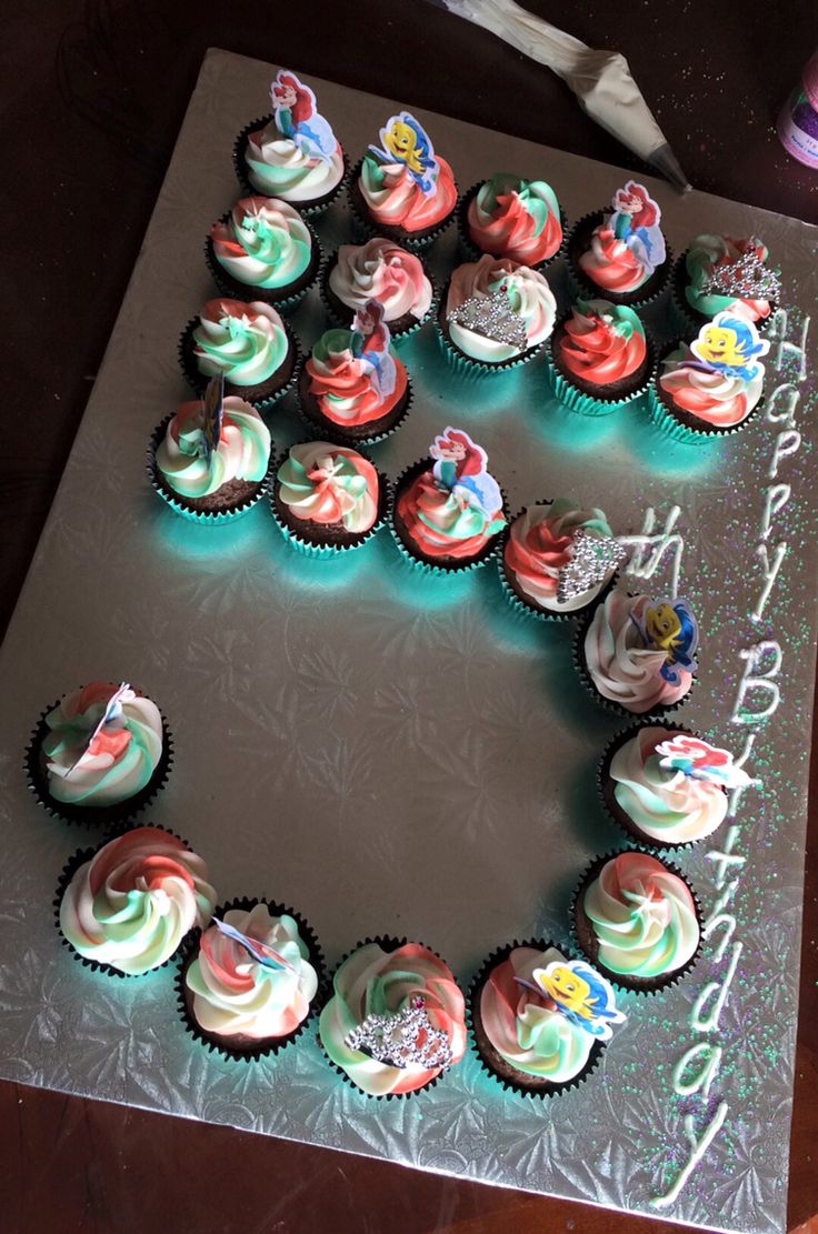 cupcakes are arranged in the shape of an e on a sheet that says happy birthday