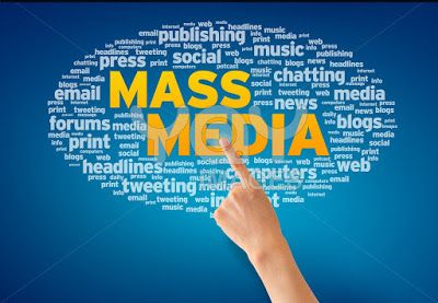 the word mass media is written in many languages and it appears to be hand pointing at something