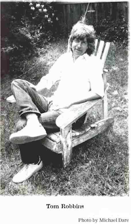 a black and white photo of a person sitting in a chair