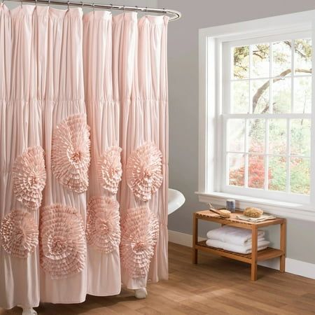 a pink shower curtain with flowers on it in front of a white bath tub and window