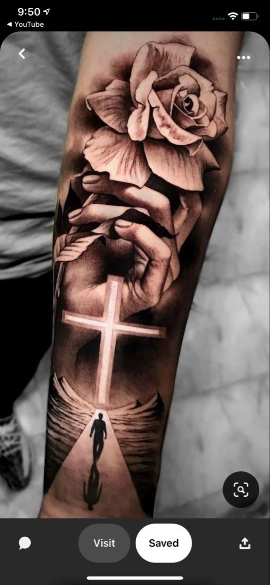 a person with a cross and flowers on their arm