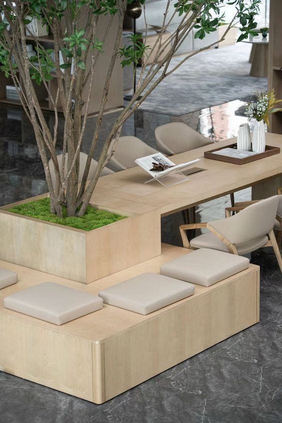 a table with benches and a tree in the center is made out of plywood