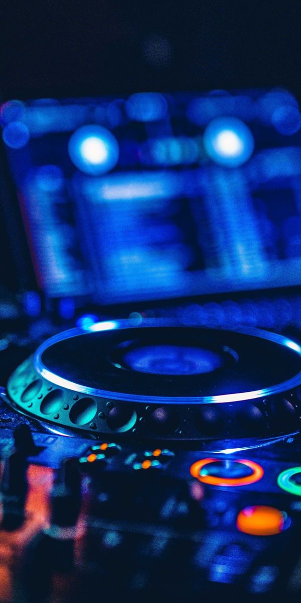 a close up view of a controller on a laptop computer with blurry lights in the background