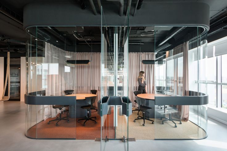 an office with glass walls and desks