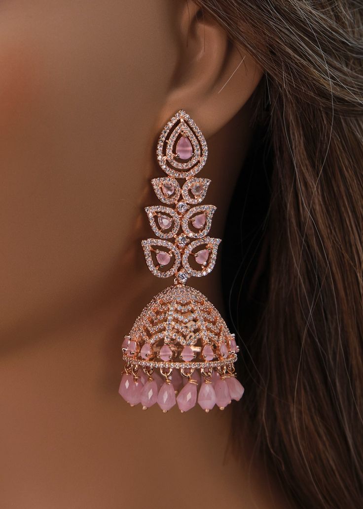 A premium quality statement CZ long jhumki earrings with Monalisa Stone and Beads tassels. Add a pop of color with this trendy long Jhumki for a touch of sparkle in your festive looks. Length: Approx. 3" Weight of each earring: 21 gms Push-Back closure Finish: Rose Gold Polish High-quality brass as the base metal. Availability: In-Stock. *Color may vary slightly due to light condition & photography. Jewelry Care: Keep away from moisture. Allow perfumes and lotion to dry before wearing. Store in Festive Nails Indian, Dreamy Earrings, Diamond Earrings Indian, Festive Accessories, Gold Jhumkas, Stylish Jewelry Accessories, American Diamond Earrings, Beads Tassels, Photography Jewelry