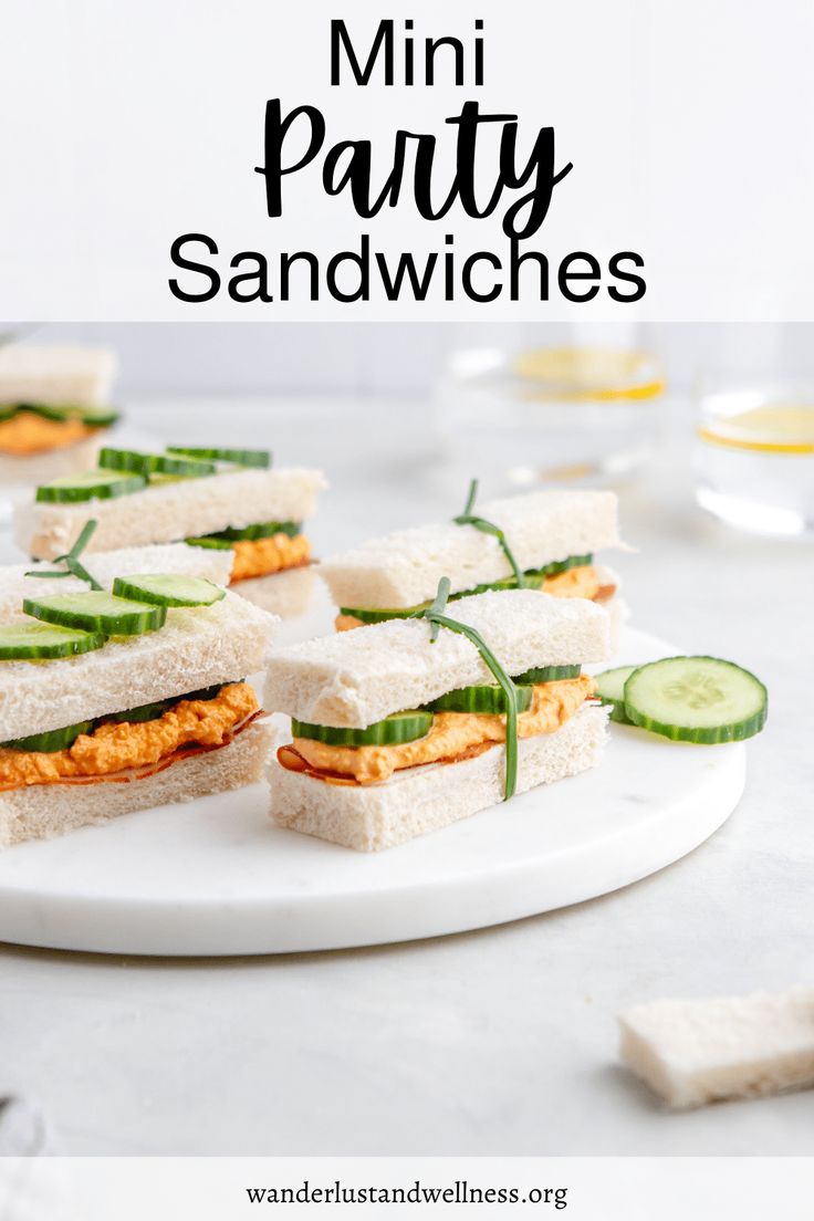 mini party sandwiches with cucumber and cheese on a white serving platter for an appetizer