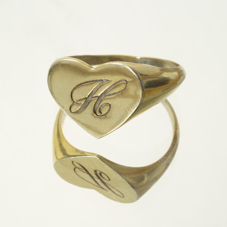 The heart signet ring is a classic, and this one is personalized with an inset monogram. This item is engravable with text or monogram of your choice at no extra cost. The initals are engraved onto the ring and embedded in the 3D model for a flawless embossed finish. You may choose to customize this ring with different images, letters or words. A render of your custom design will be sent to you before production. Heart width: 14mm Heart height: 11mm A few notes about our gold: - Though we do not Classic Jewelry For Valentine's Day, Gold Engraved Initials Ring In 14k, Personalized Gold Heart-shaped Initial Ring, Personalized 14k Gold Signet Ring For Anniversary, 14k Gold Monogram Engraved Ring, Personalized Gold Heart Initial Ring, Yellow Gold Engraved Monogram Ring, Classic Heart Ring For Valentine's Day, Classic 14k Gold Rings For Personalized Gift