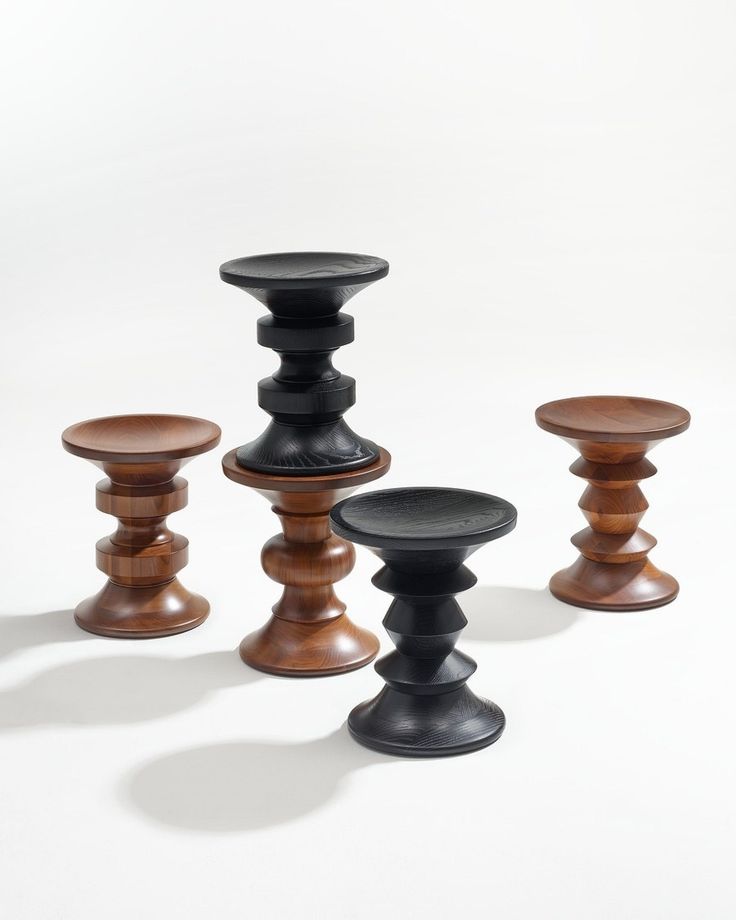 three wooden candlesticks and one black candle holder