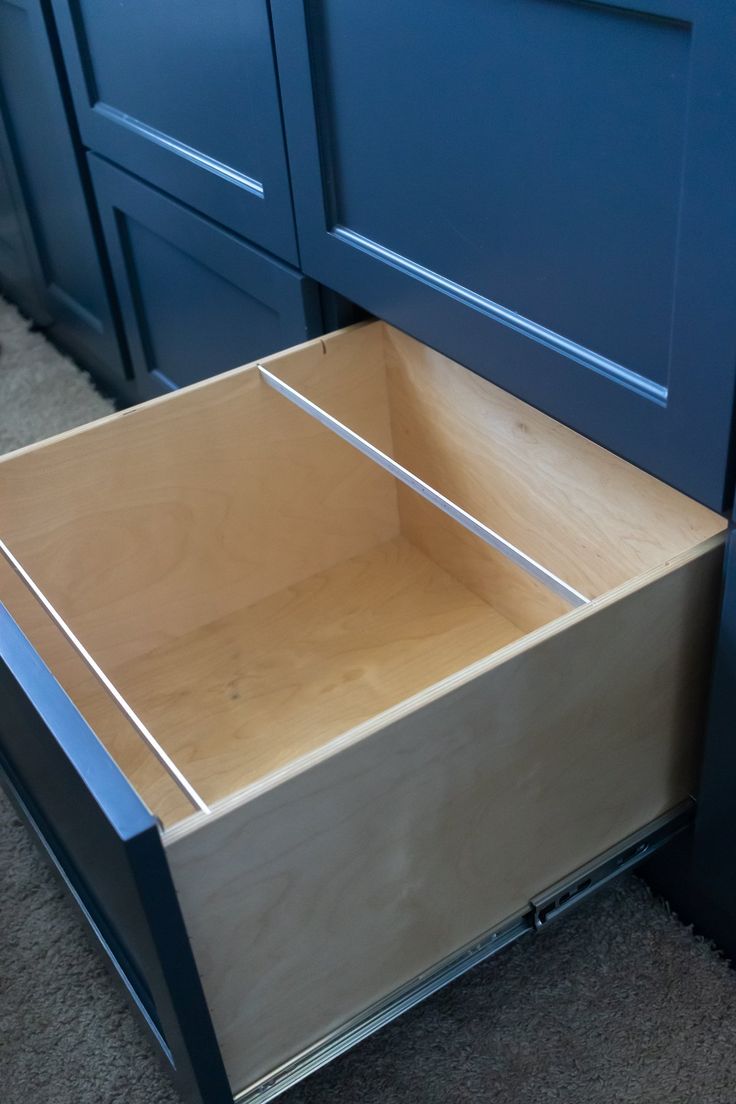 an empty drawer in the middle of a kitchen