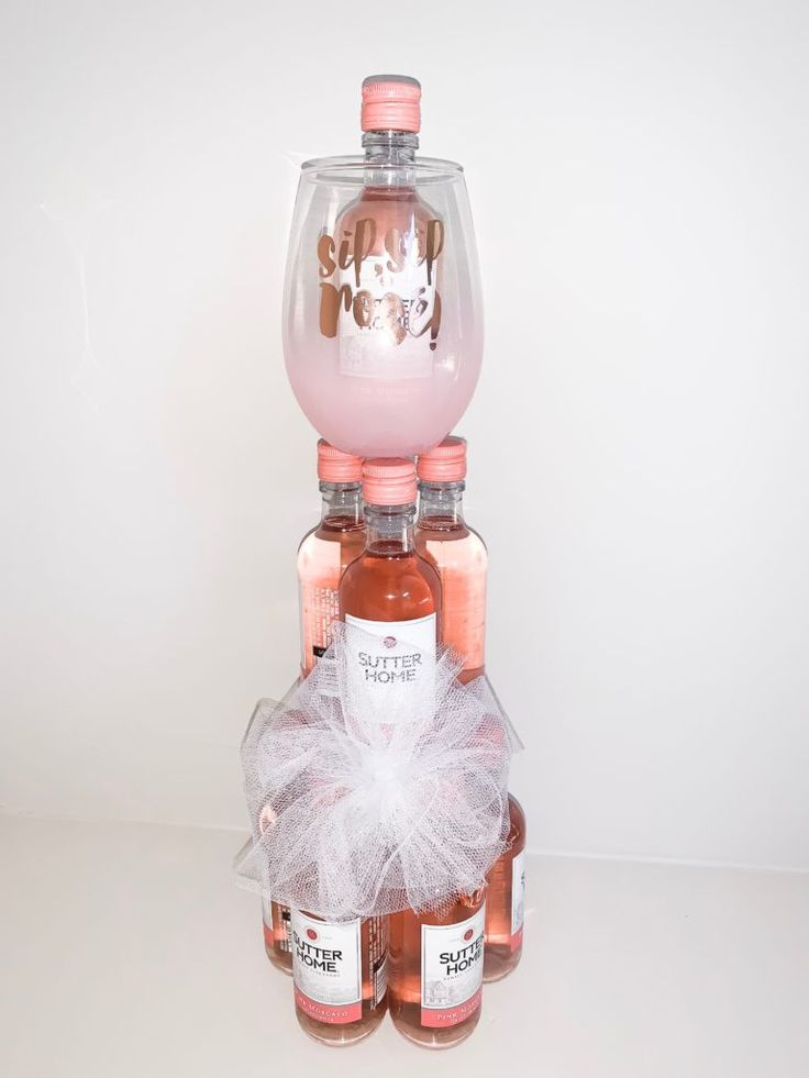 two bottles of booze are stacked on top of each other with a bow around the bottle