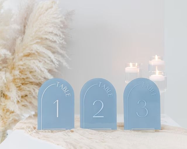 three frosted blue numbers sitting on top of a bed