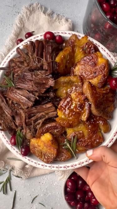 a bowl filled with meat and cranberries on top of a table