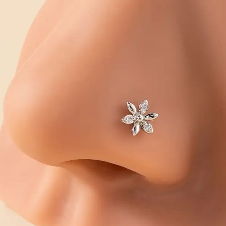 a close up view of the side of a woman's ear with a flower on it