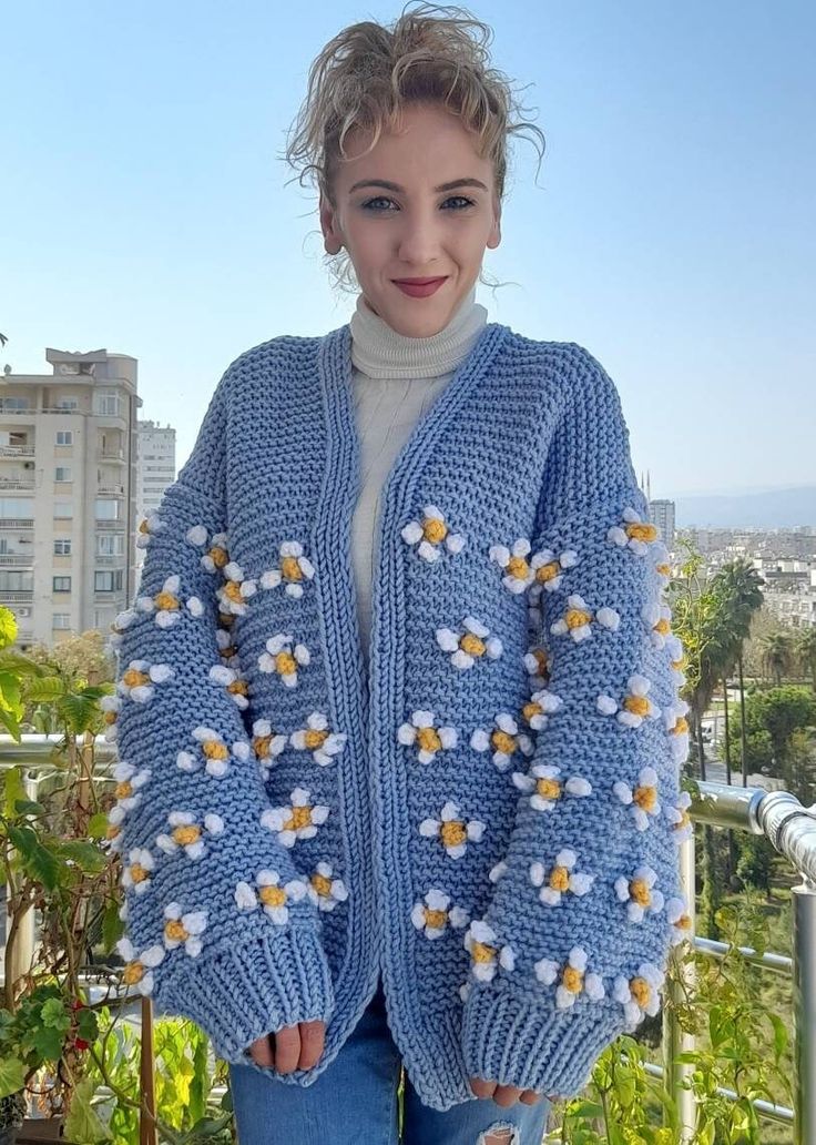 3D Daisy chunky Knit Cardigan with quality yarns that you can wear for years It is knitted, the handmade daisy cardigan has been knitted with non-fading threads for many years, the daisy balloon sleeve cardigan was originally hand knitted by me. You can give it as a gift to your girlfriend, a gift to your wife on your wedding anniversary, or a gift to your mother on mother's day, which will make you feel special. Shipping takes as falows. USA : 3-7 days Europe : 3-6 days Australia :3-7 days Mate Crochet Acrylic Cardigan For Winter, Winter Crochet Acrylic Cardigan, Spring Blue Chunky Knit Outerwear, Winter Acrylic Crochet Cardigan, Hand Knitted Acrylic Outerwear For Spring, Spring Knitted Acrylic Sweater Coat, Winter Knitting Pattern In Blue Yarn, Blue Yarn Knitting Pattern For Winter, Winter Blue Yarn Knitting Pattern