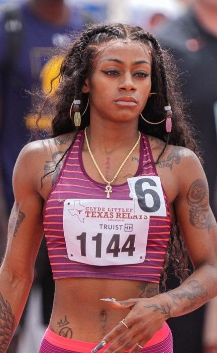 a woman with tattoos on her arm and chest