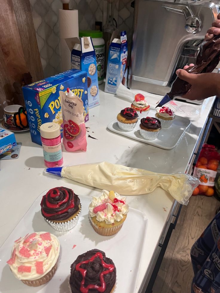 several cupcakes are on the counter ready to be cut and eaten by someone