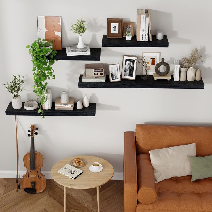 a living room filled with furniture next to a wall mounted shelf above a coffee table